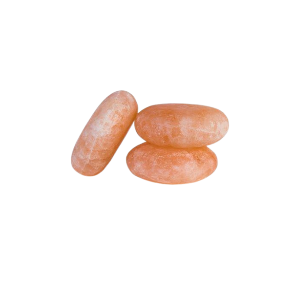 Two polished oval Himalayan salt massage stones on a white background