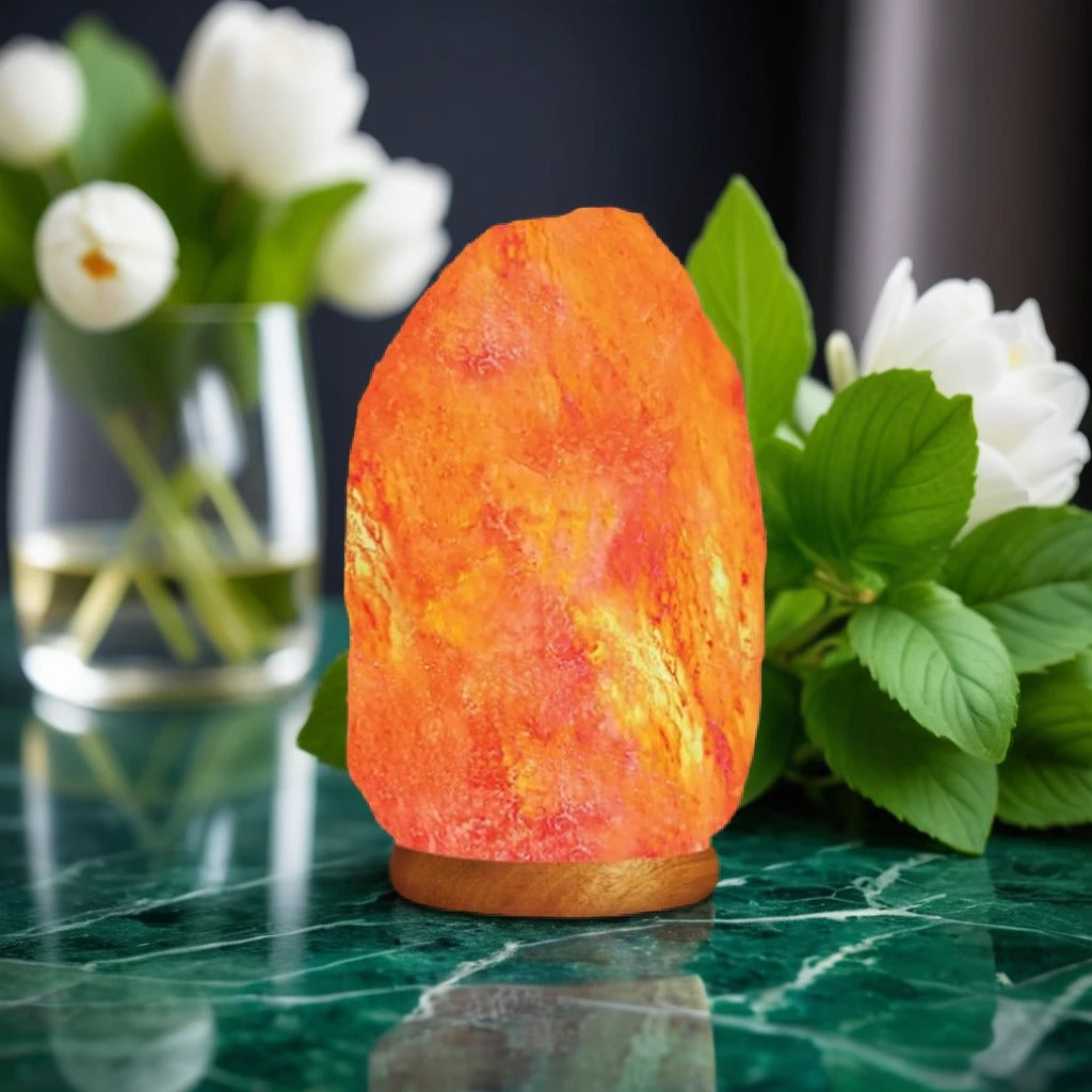 Natural unpolished Himalayan salt lamp glowing amber, showing raw crystal texture and iron-oxide veining