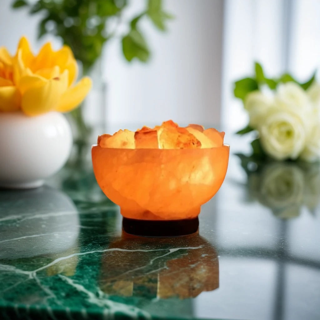 Hand-carved Himalayan salt fire bowl lamp filled with glowing polished rock chunks