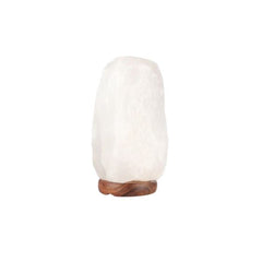 White crystal Himalayan salt lamp on a wooden base against a white background