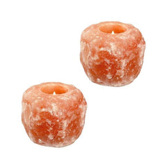 Two Himalayan salt candle holders, each with a lit tealight candle, on a white background