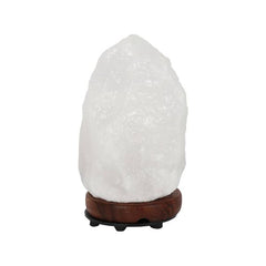 White crystal Himalayan salt lamp on a dark wood base against a white background