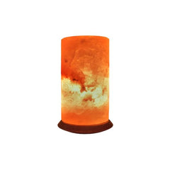 Cylindrical Himalayan salt lamp glowing amber on a dark wood base against a white background