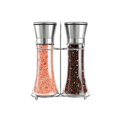 Two glass grinders on a stand, one filled with pink Himalayan salt and one with mixed peppercorns
