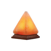 Pyramid-shaped Himalayan salt USB lamp glowing amber on a wooden base against a white background