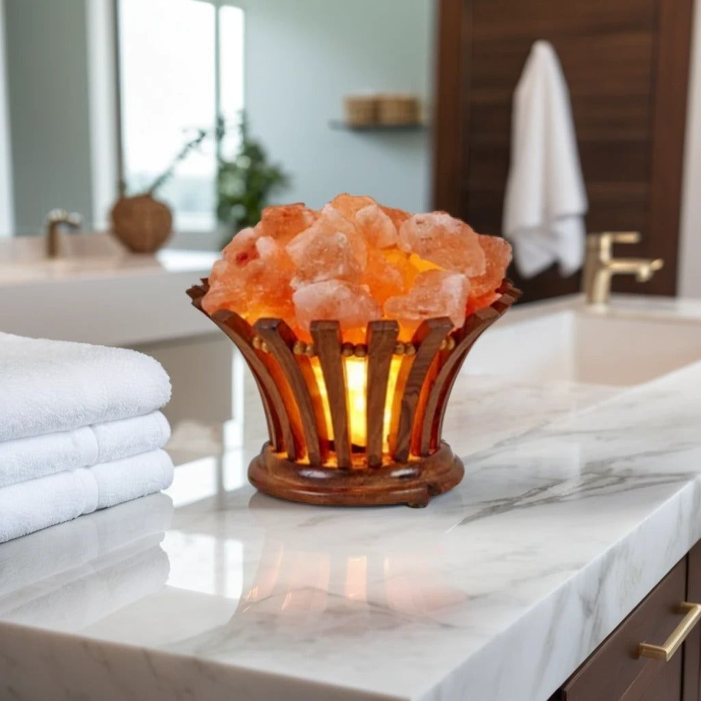 Flower-shaped wood-slat salt lamp filled with glowing Himalayan salt chunks on a marble bathroom counter