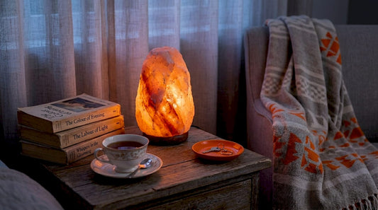 Glowing Himalayan salt lamp on wooden table