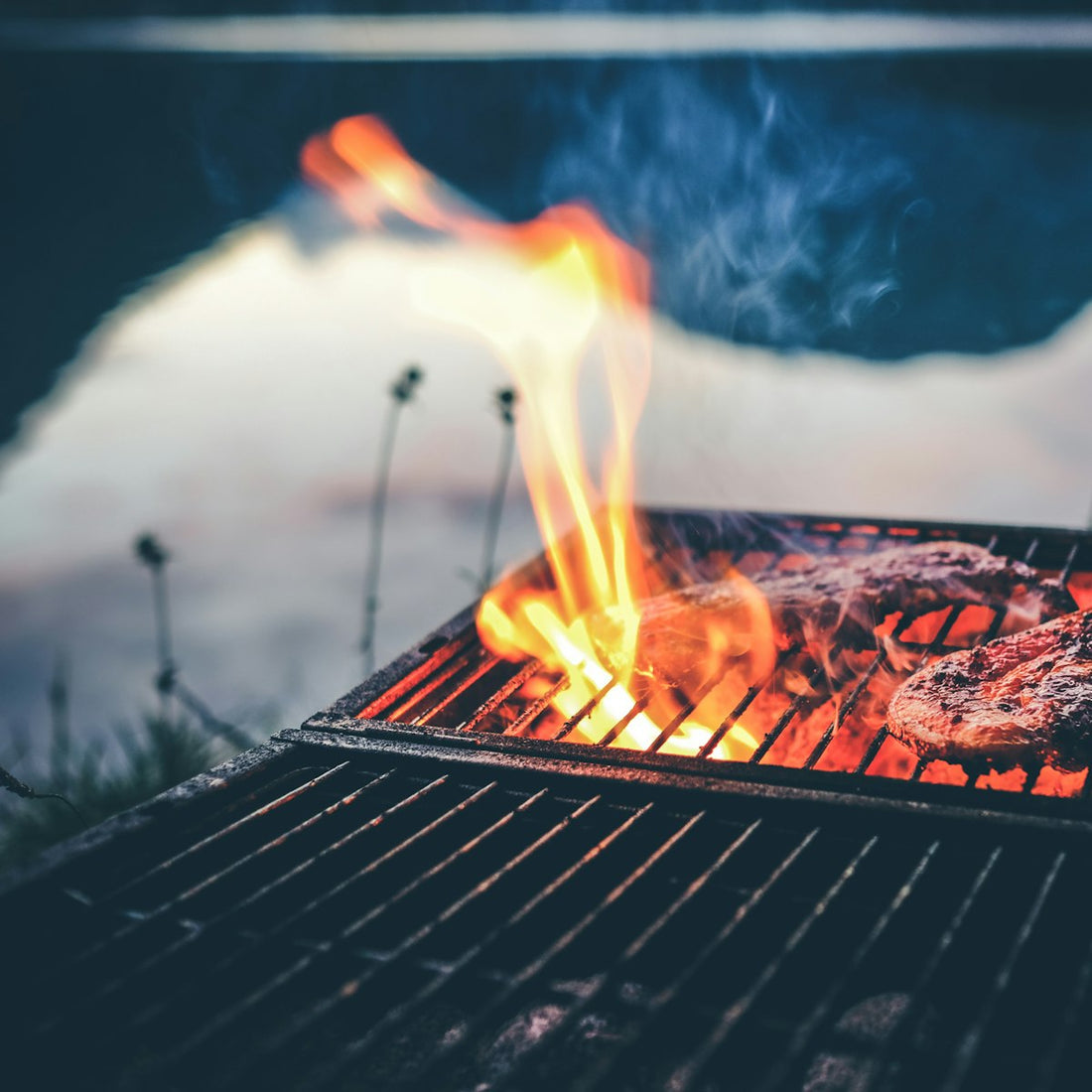 Steak searing over open charcoal flames, the kind of high-heat grilling suited to a salt block