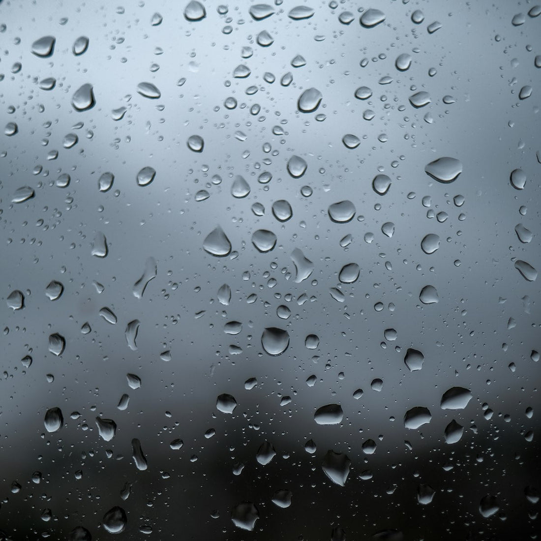Water droplets condensing on a window, illustrating indoor humidity that affects salt lamps