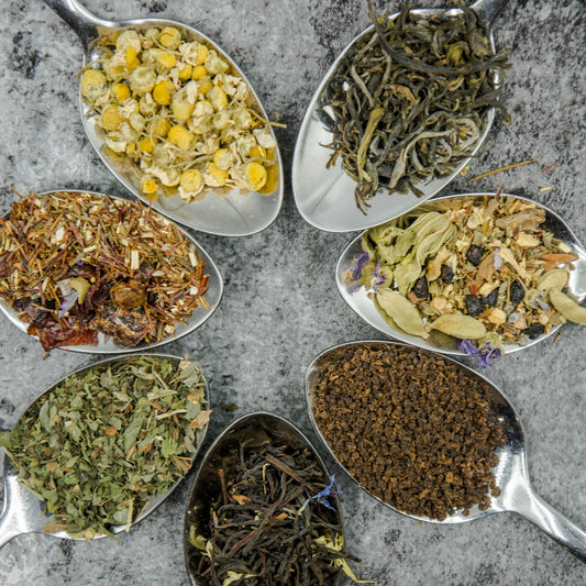 Assorted natural spices and salts on spoons, representing clean label seasoning choices