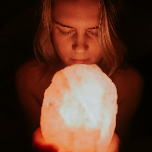 Person holding a Himalayan salt lamp, illustrating what to look for when choosing one
