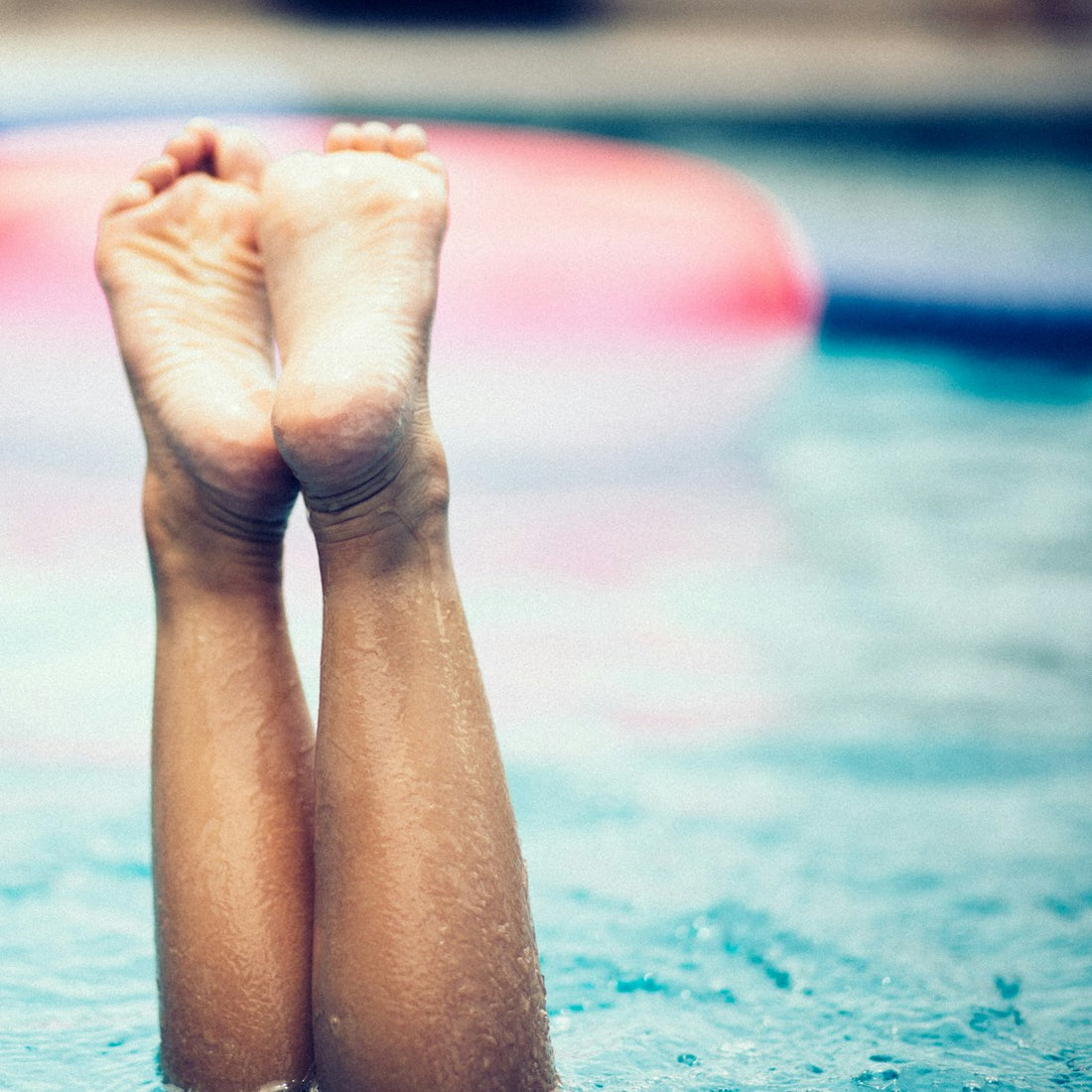 Bare feet soaking in water, evoking a relaxing Himalayan salt foot soak