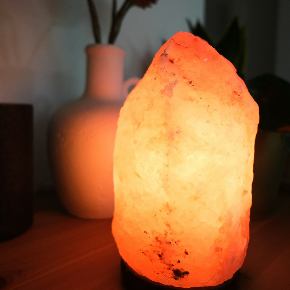 Himalayan salt lamp glowing on a wooden table