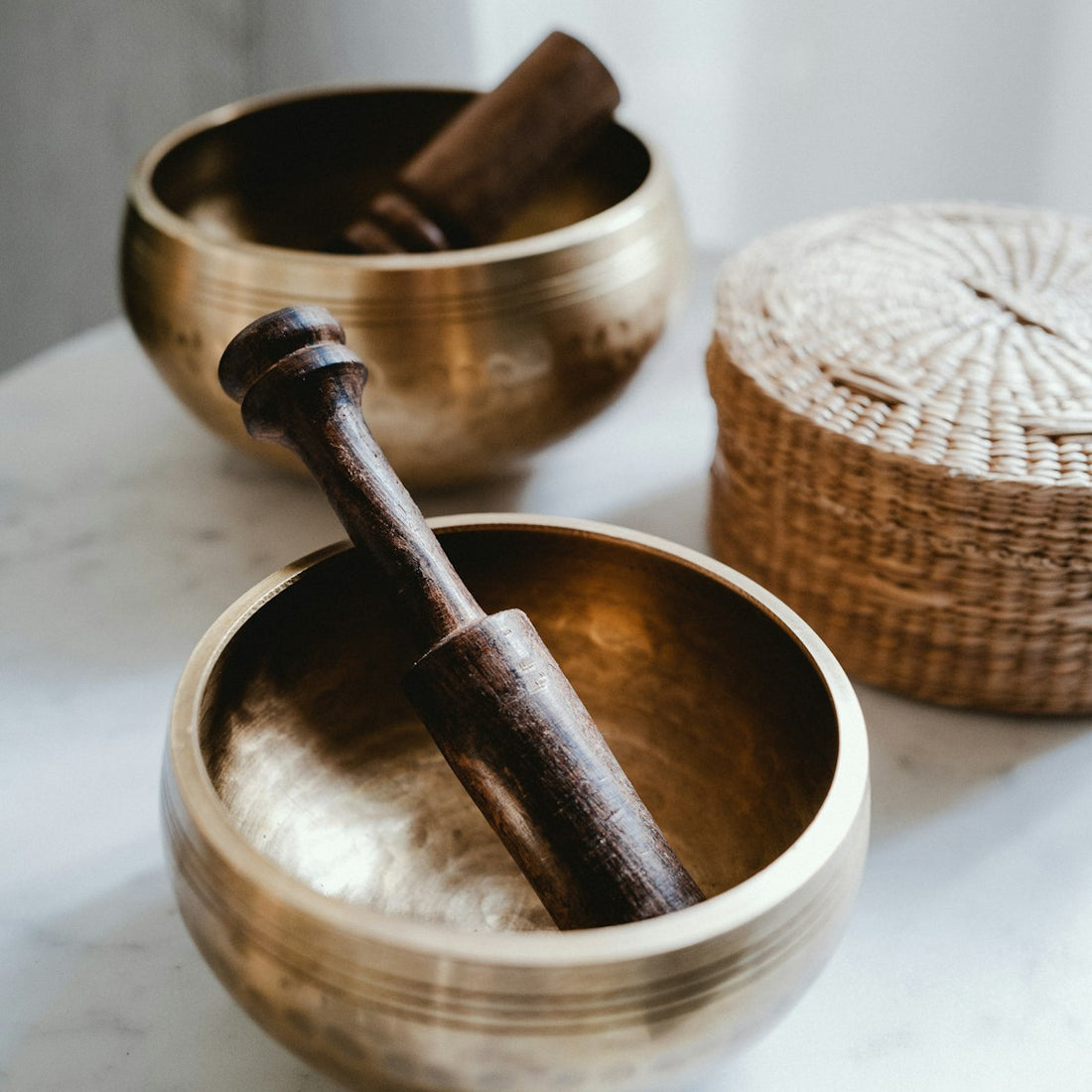 Wooden mortar and pestle used for grinding coarse Himalayan salt crystals at home