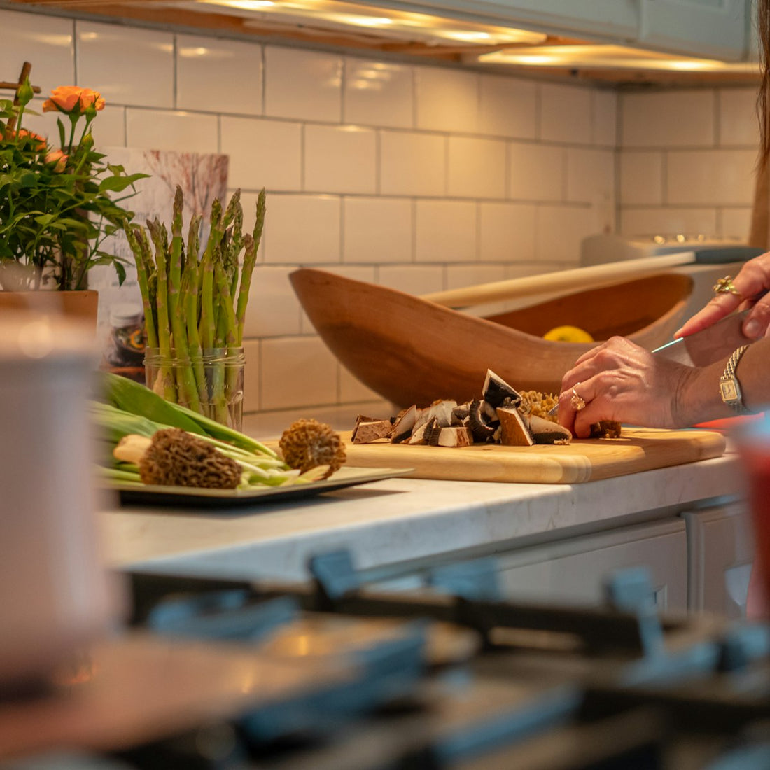 A home cook preparing fresh ingredients in the kitchen, ready to season with unrefined salt