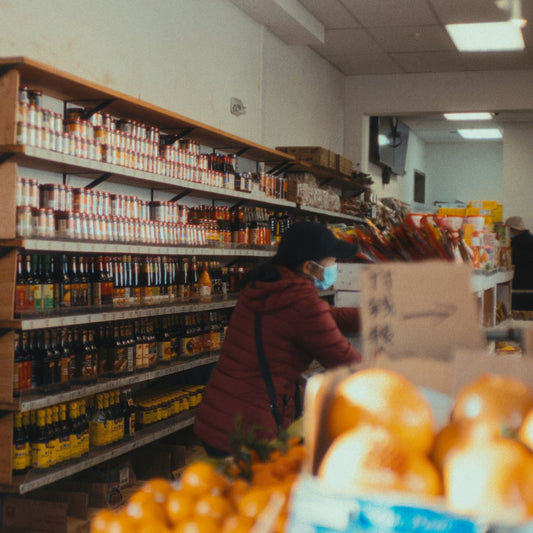 A shopper examining products on a store shelf, choosing carefully as any salt buying guide advises