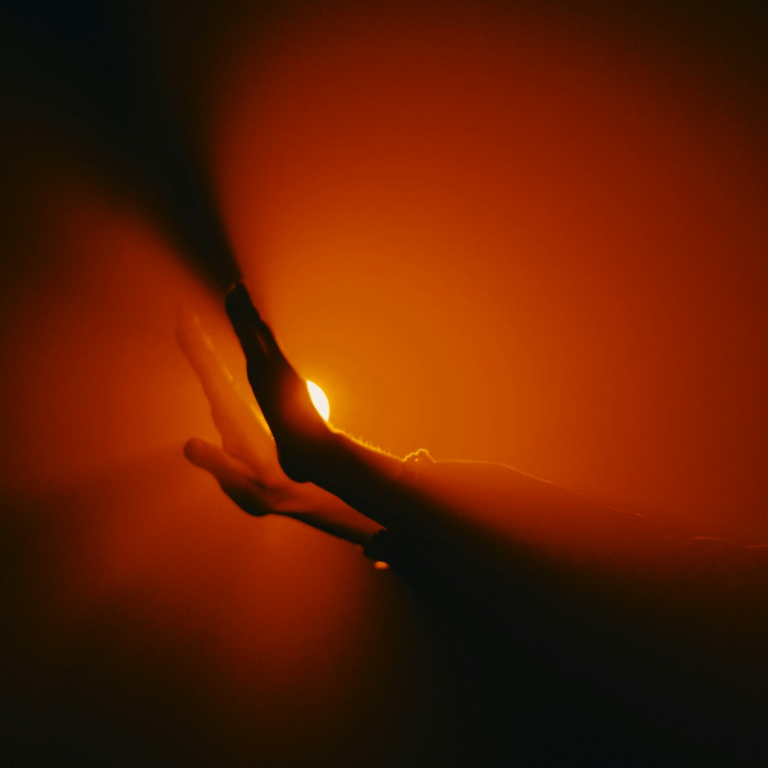 Close-up of a hand holding a light bulb, illustrating how to replace a salt lamp bulb
