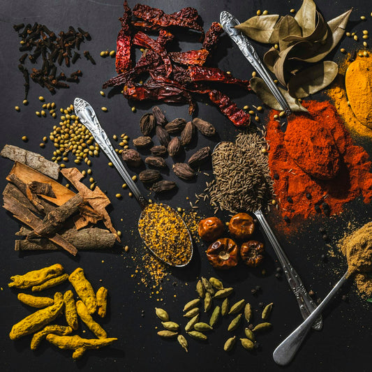 Assorted spices and salts laid out on a table, comparing artisan salt varieties
