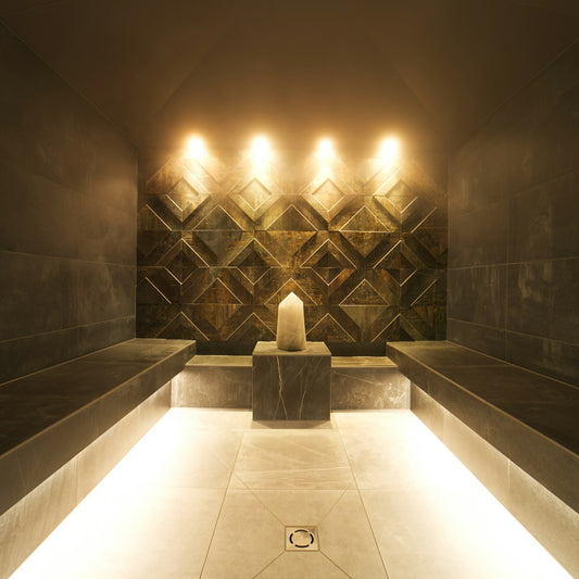 Calm spa treatment room with ambient candlelight, evoking a salt therapy session space