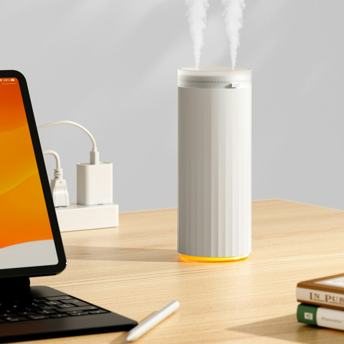 White humidifier releasing mist on a wooden desk, illustrating home air quality tools linked to allergies