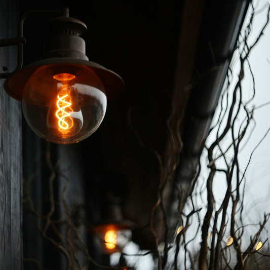 Close-up of a warmly glowing Edison light bulb filament, the type used in salt lamps