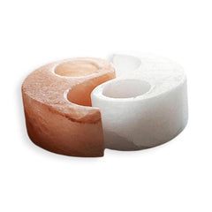 Pink and white Himalayan salt yin yang candle holder, unlit, showing the two carved tealight wells