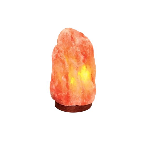 Natural Himalayan salt lamp glowing amber on a dark wood base against a white background