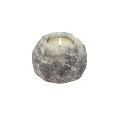 Grey Himalayan salt candle holder with a lit tealight candle against a white background
