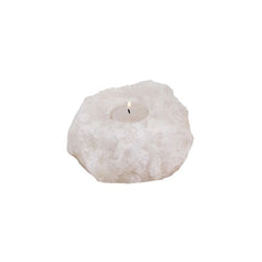 White Himalayan salt crystal candle holder with a lit tealight candle on a white background