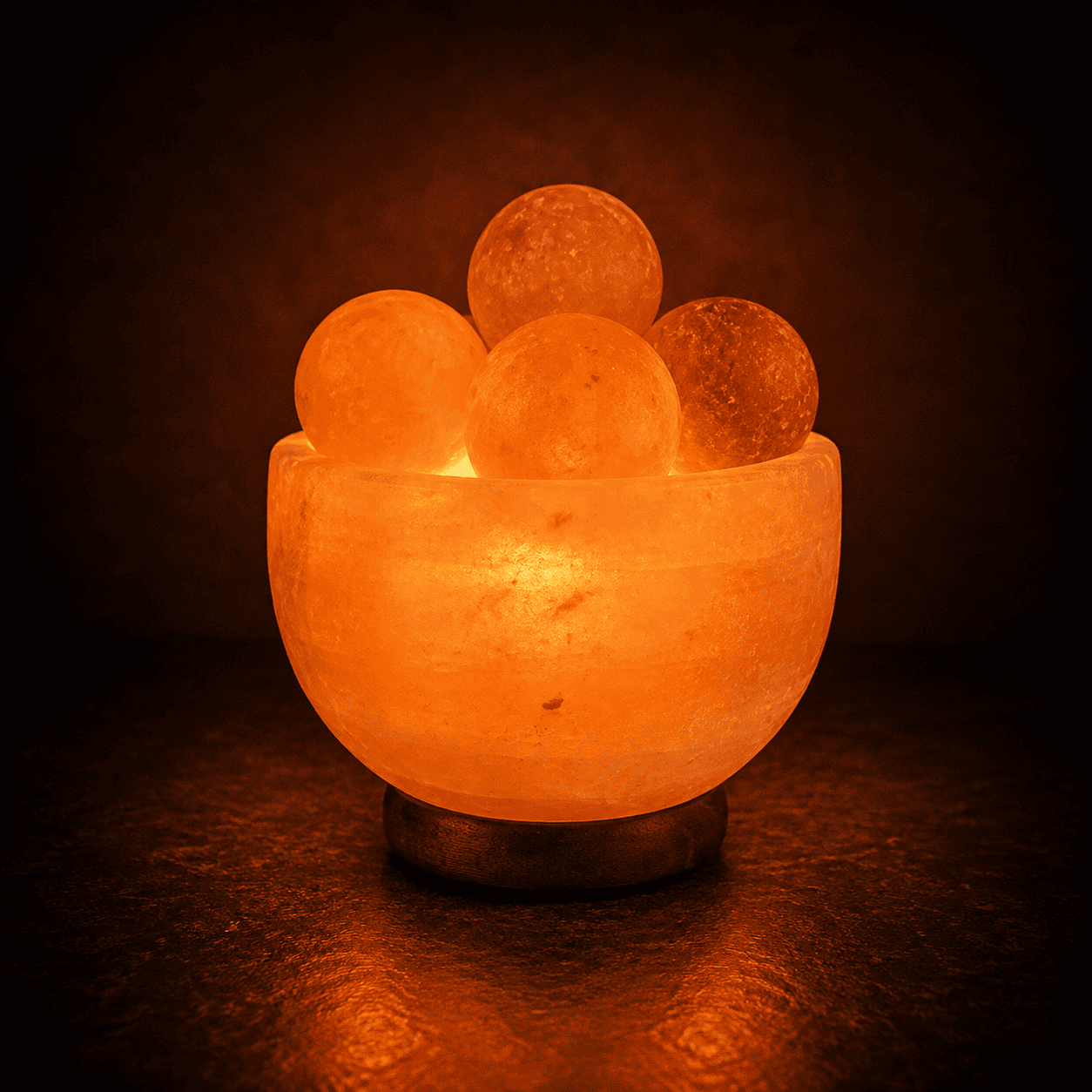 Fire Bowl Himalayan Salt Lamp with Massage Balls – studio photo lit against a dark background